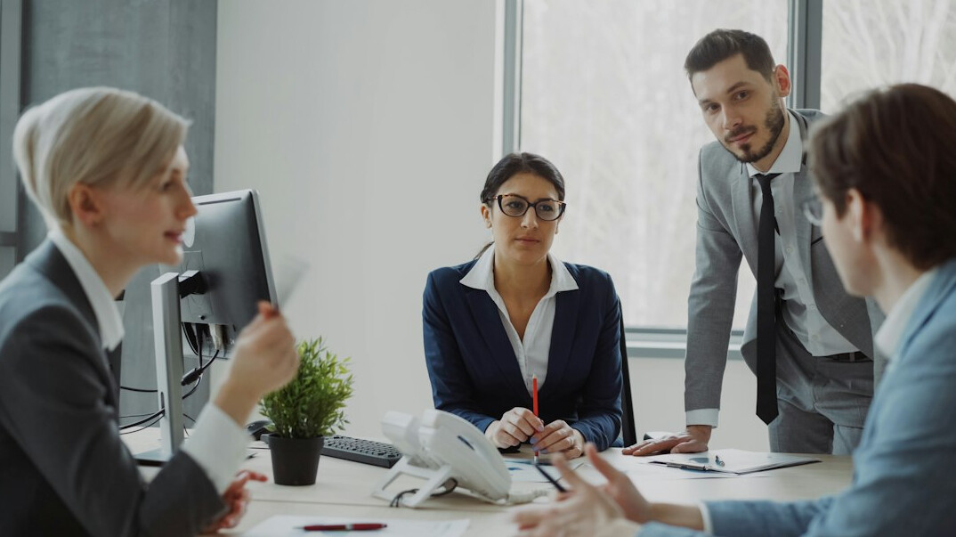 Colleagues having a discussion in an open office